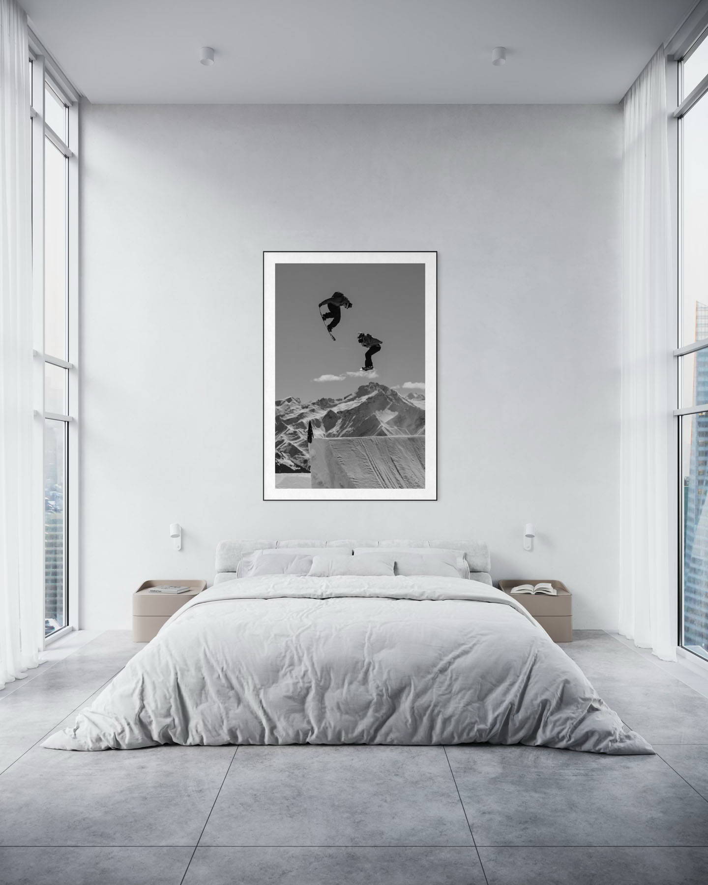 Schwarzweissaufnahme eines Snowboarders in Laax, der hoch ueber einem Kicker vor alpiner Bergkulisse springt.